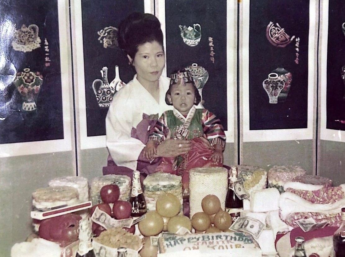 Betty Edmonds as a baby in a hanbok on her mother's lap at her first-birthday celebration in Korea
